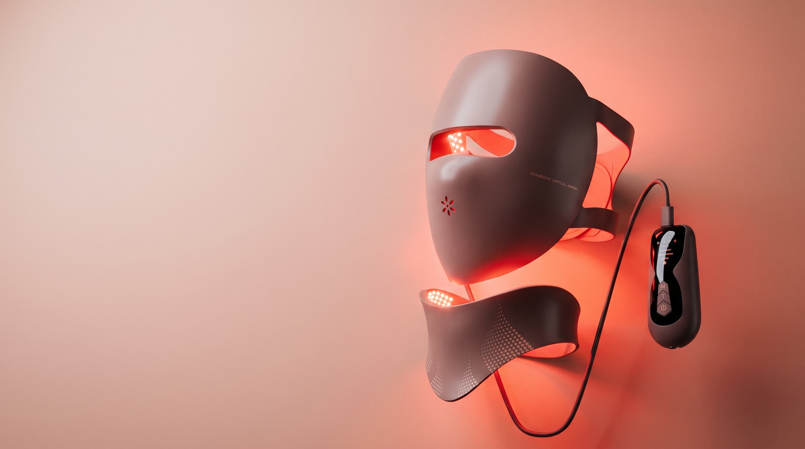 Woman wearing the Aura Ray LED light therapy mask at home